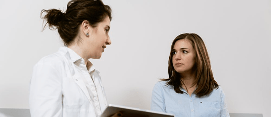 A dentist and patient in conversation about the oral-systemic health connection