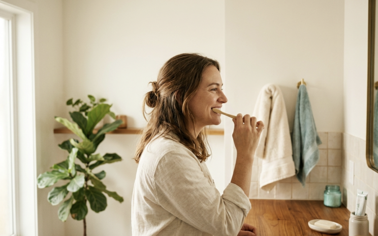 Person brushing teeth, representing daily care for wisdom teeth and heart health